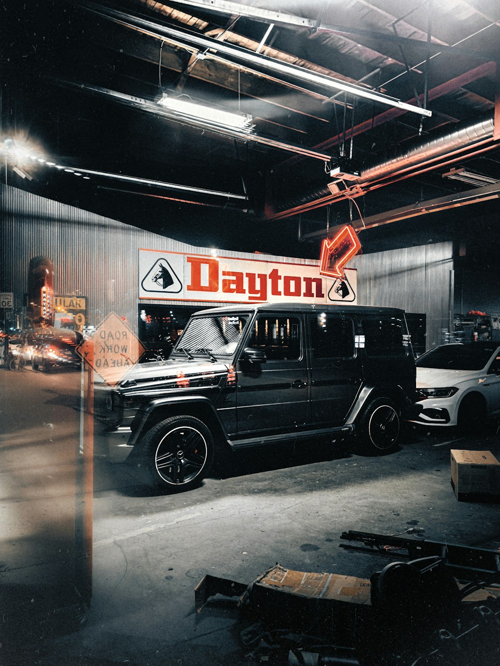 a black jeep parked in a garage next to a sign