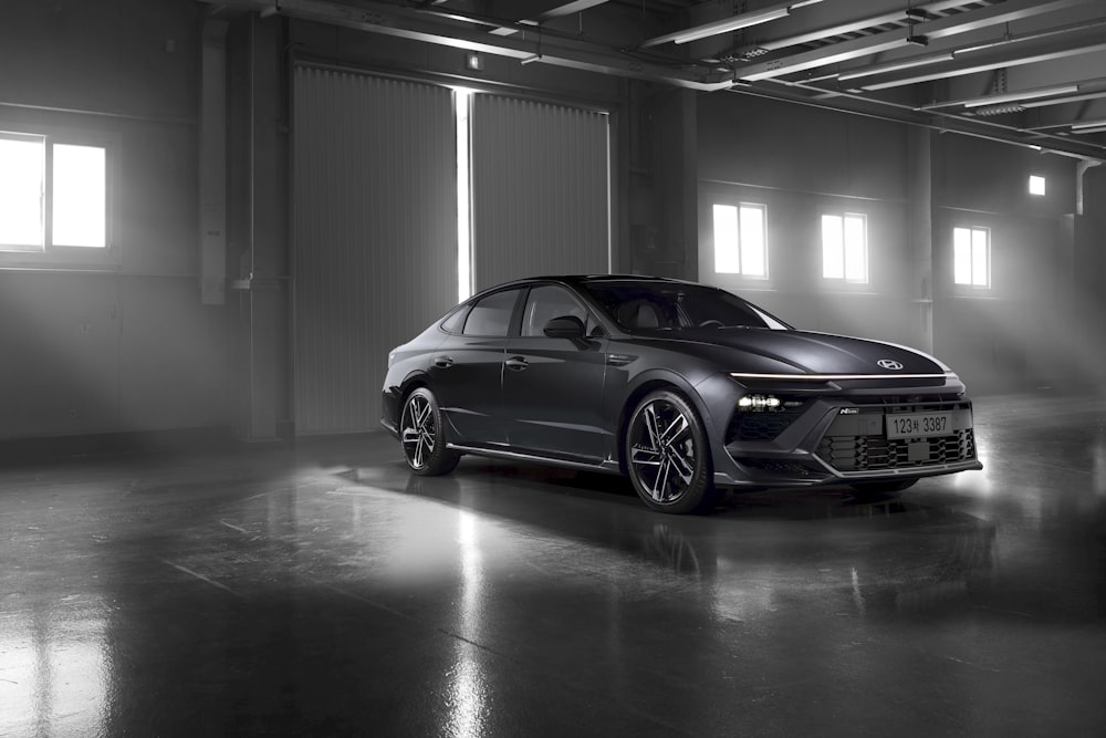 a black and white photo of a car in a garage