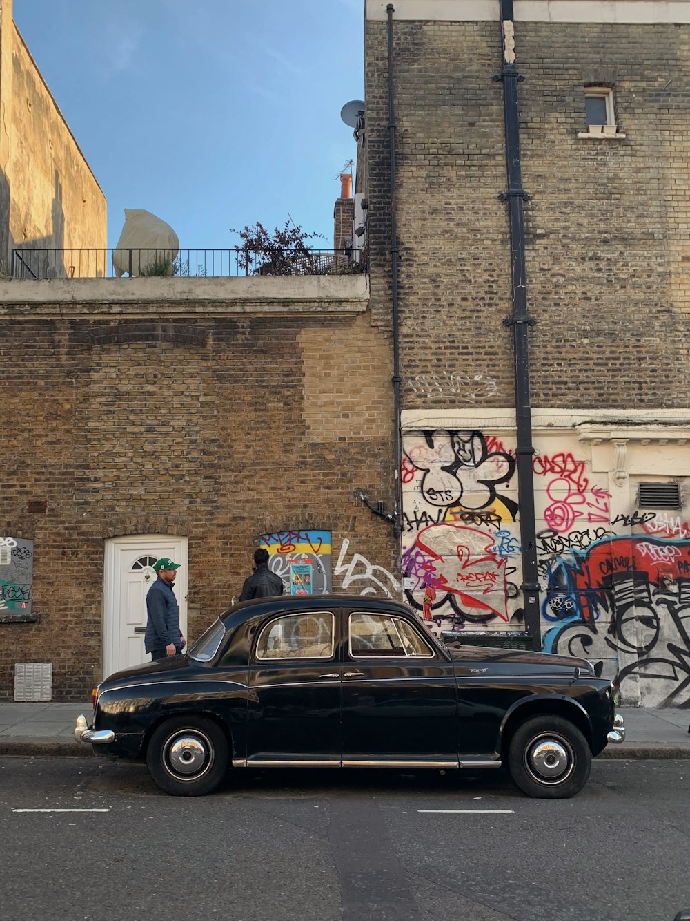 a black car parked in front of a building