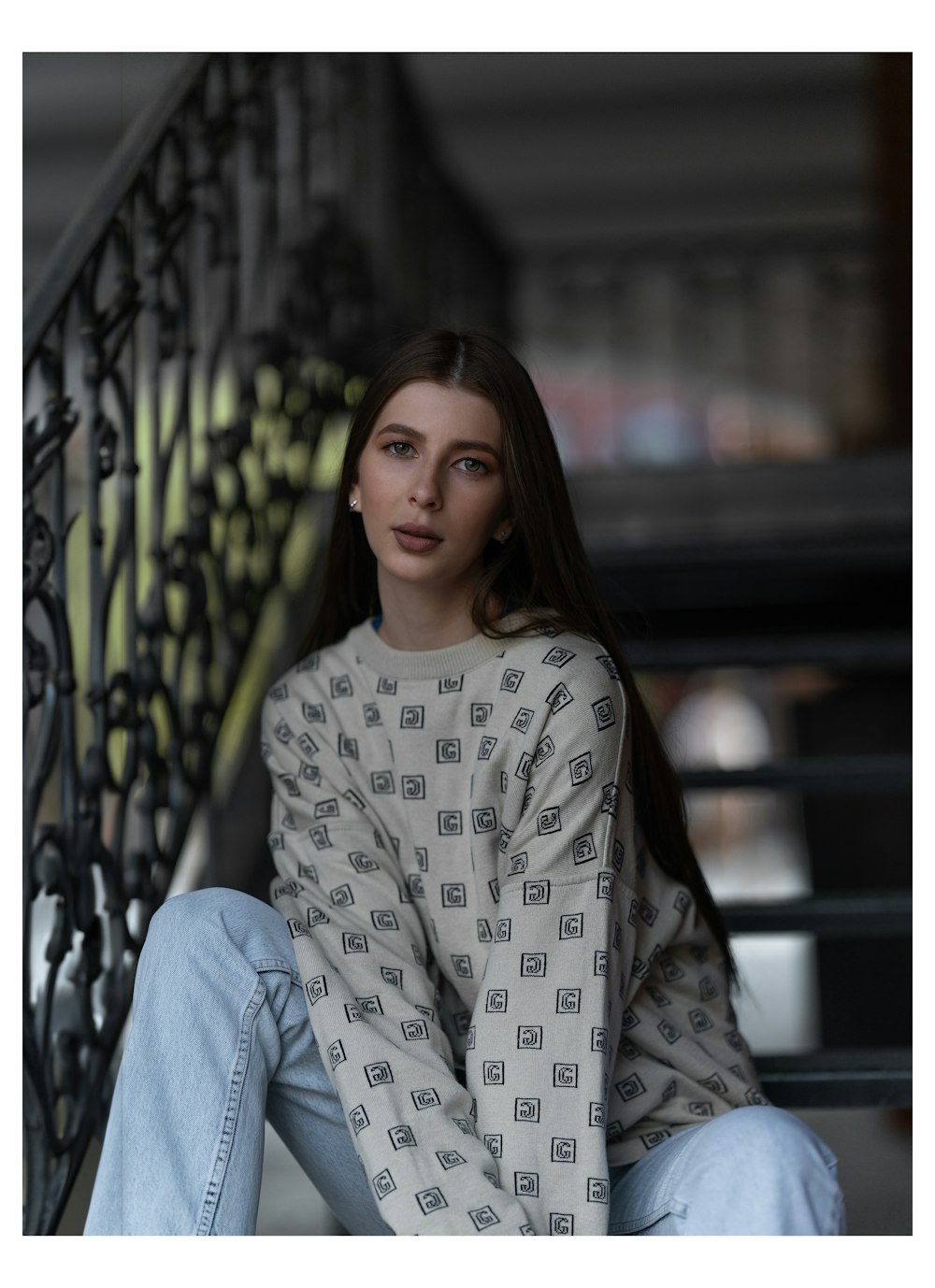 a woman sitting on the steps of a building