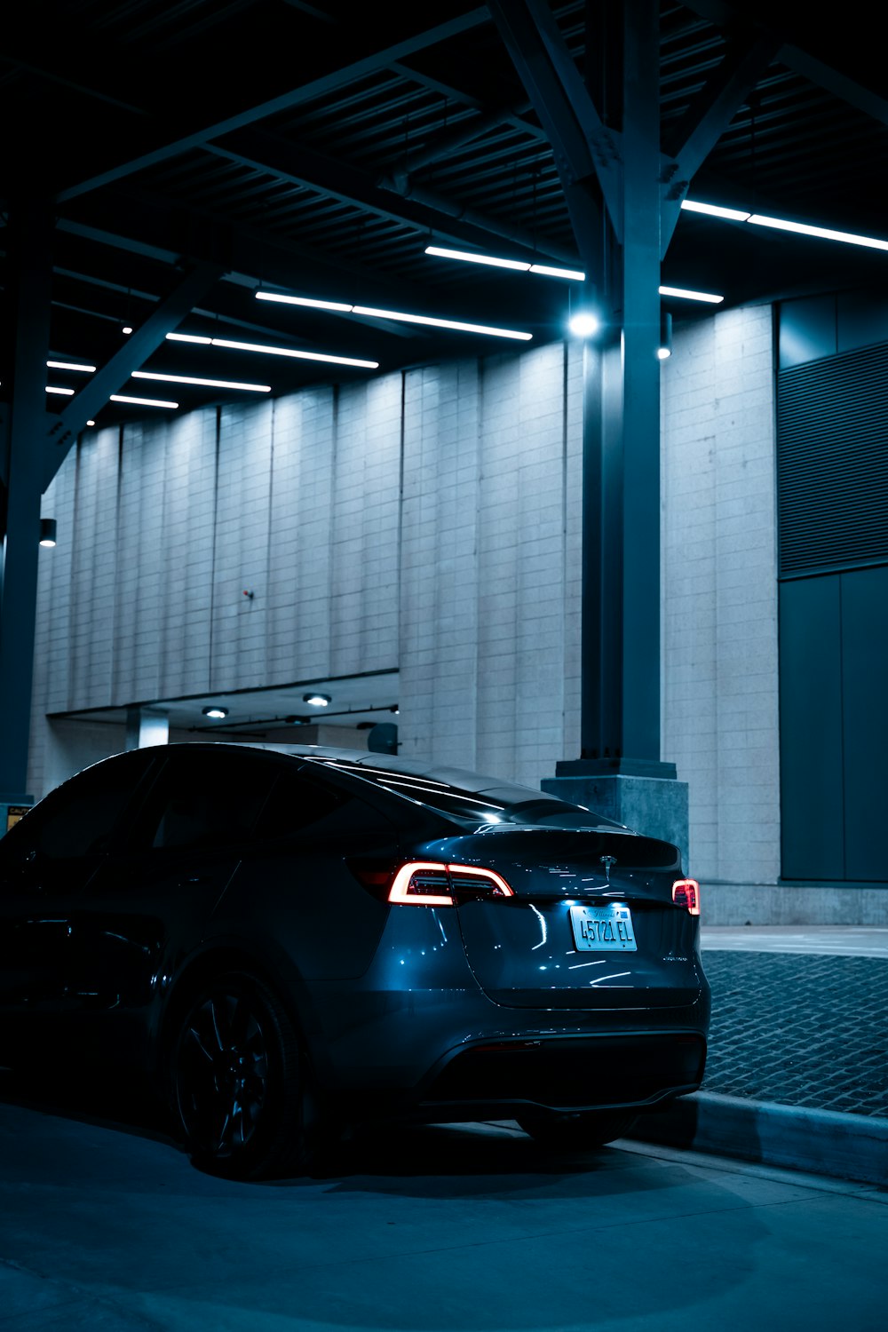 a car parked in a parking garage at night