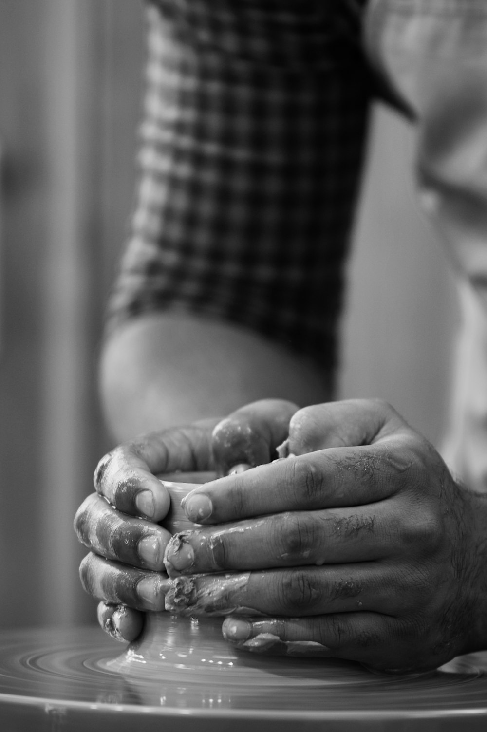 a black and white photo of a person's hands on a plate