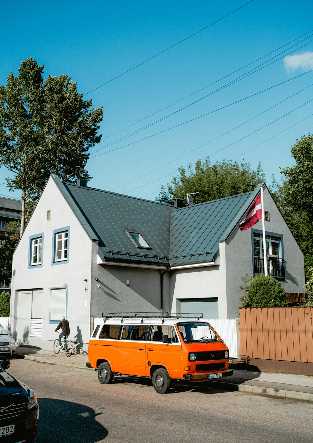 an orange van is parked in front of a house