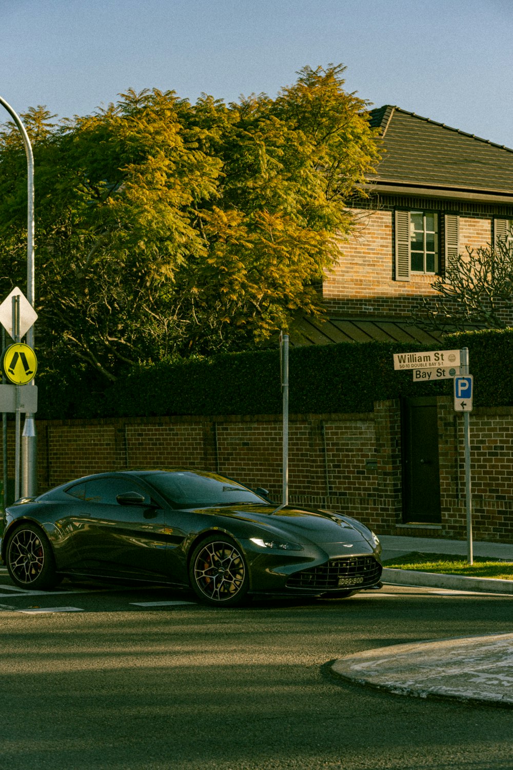 a black sports car driving down a street