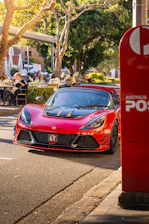 A sleek car being handed over with cash in a bright Melbourne street setting.