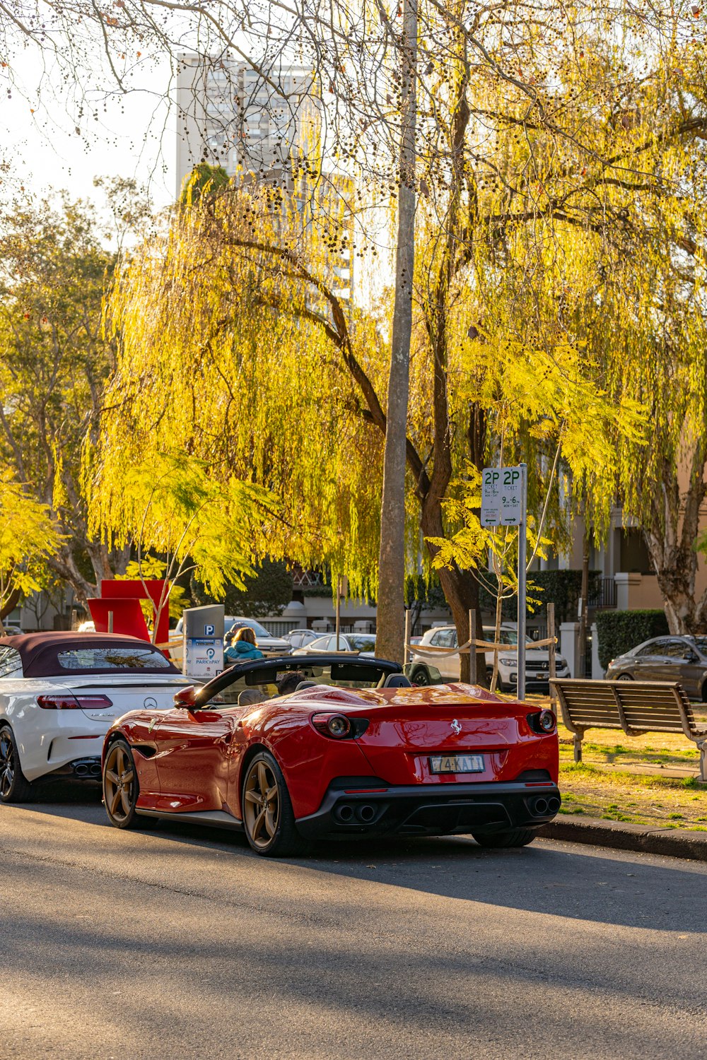 a couple of cars parked on the side of a road