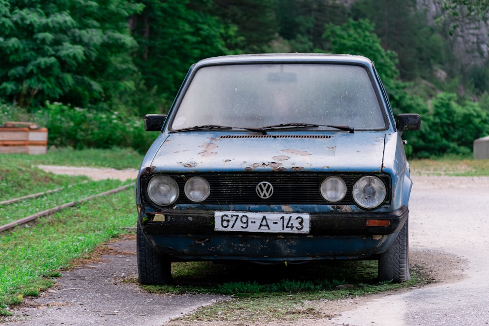 an old car parked on the side of a road