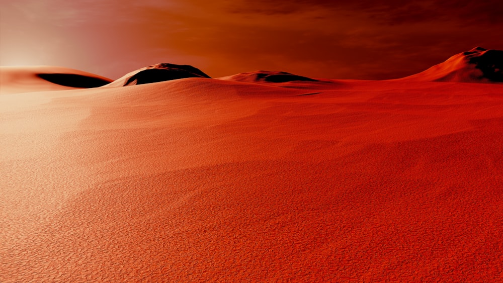 a group of hills covered in sand under a cloudy sky