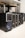 Several desktop computer towers are lined up on the floor next to each other. The computers are placed under a table in an indoor setting. The visible brands include Acer and other unspecified brands. The towers have multiple drive slots and ports visible on the front panels.