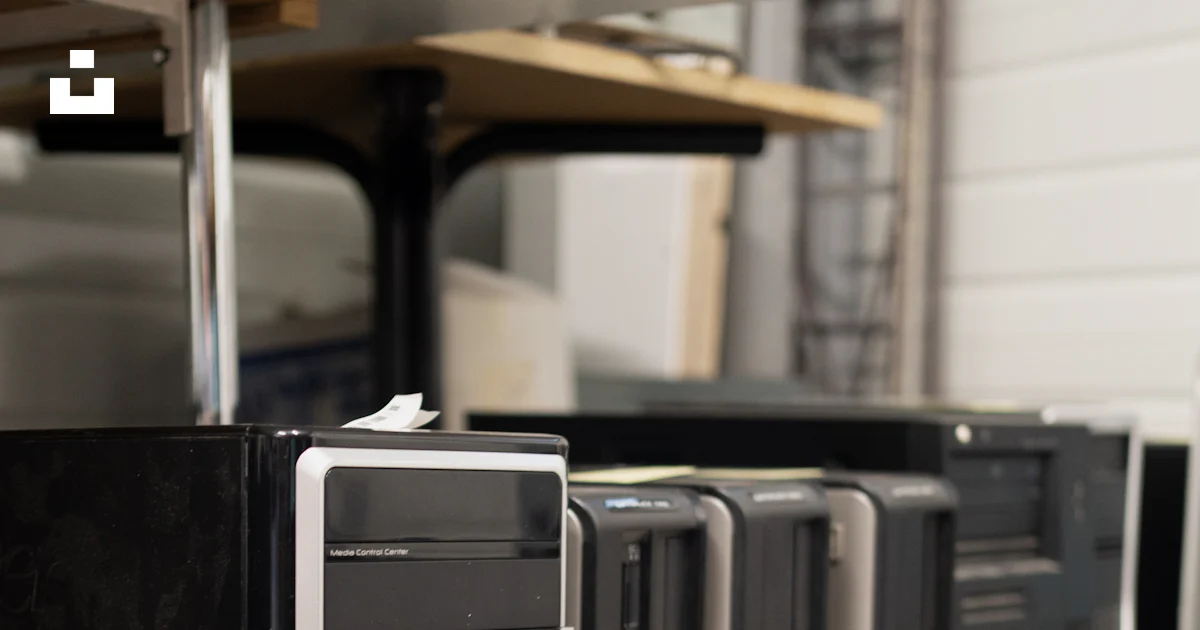 Top Bottom Computer A row of black computers sitting on top of a table photo – Free La r ...