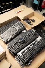 a bunch of keyboards and mouses on a table