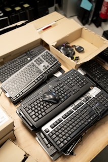 a bunch of keyboards and mouses on a table