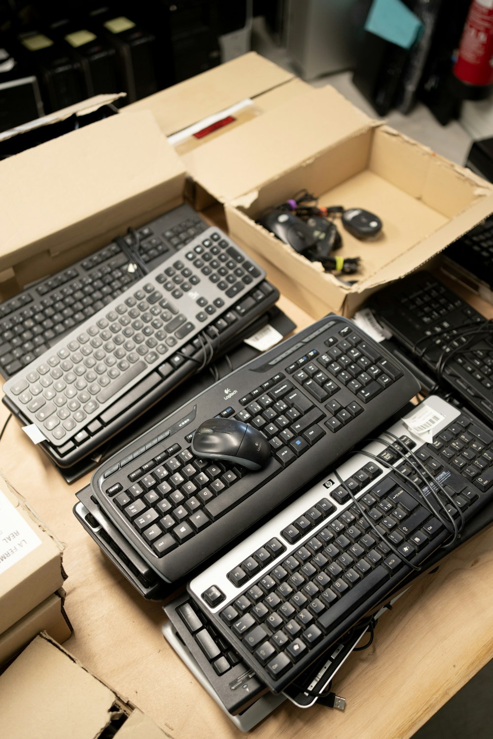 a bunch of keyboards and mouses on a table