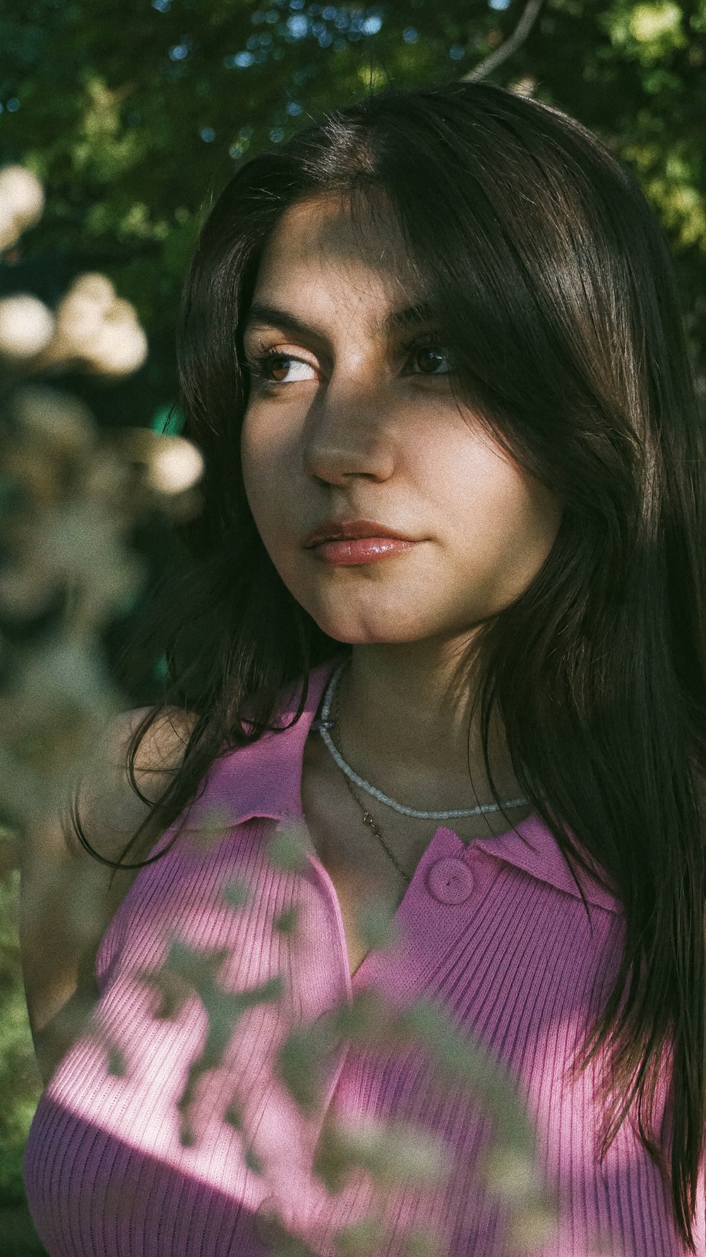 a woman in a pink shirt posing for a picture