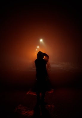 An evocative silhouette of a lone figure on a deserted street.