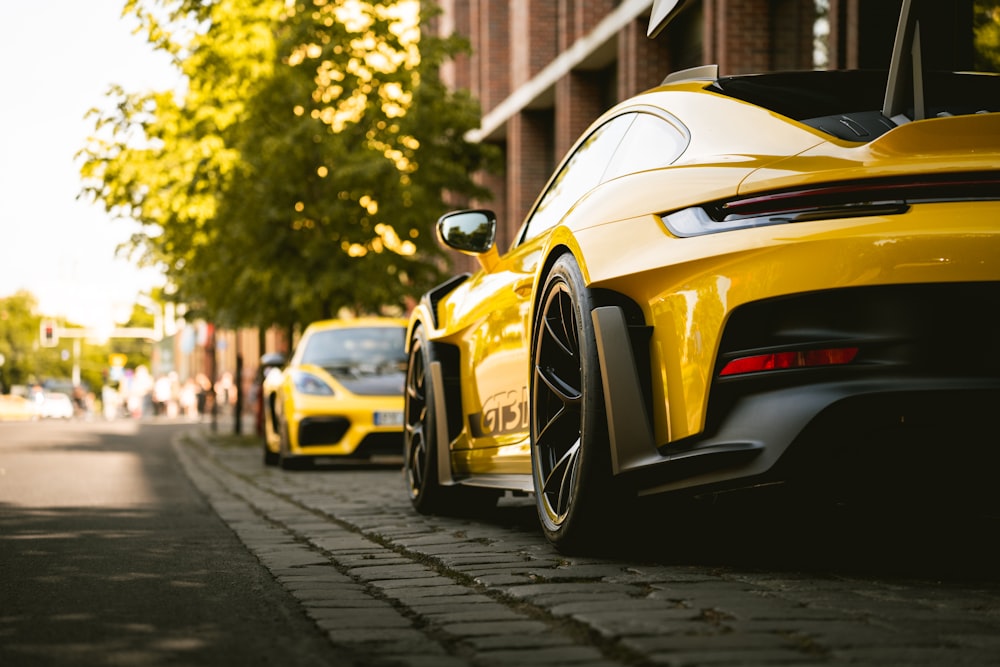 a yellow sports car parked on the side of the road