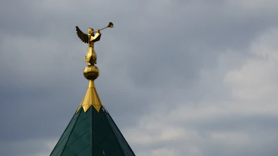 A close-up of the Judgement tarot card featuring an angel blowing a trumpet over awakening figures.