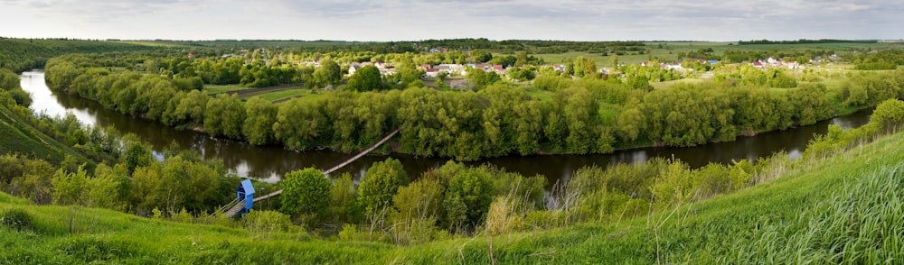 a river running through a lush green hillside