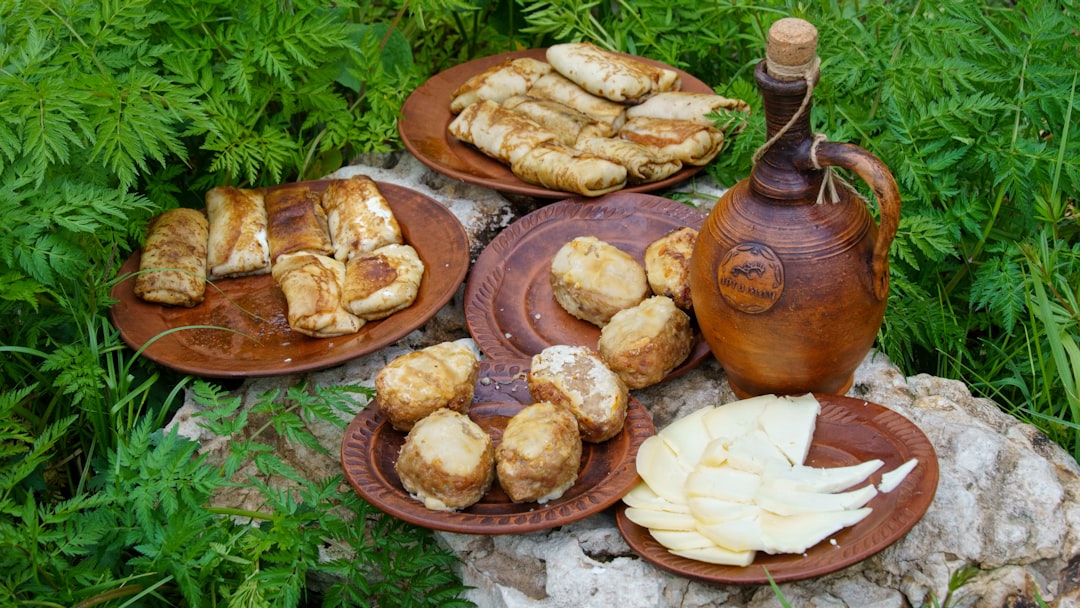 a table topped with plates of food and a tea pot,