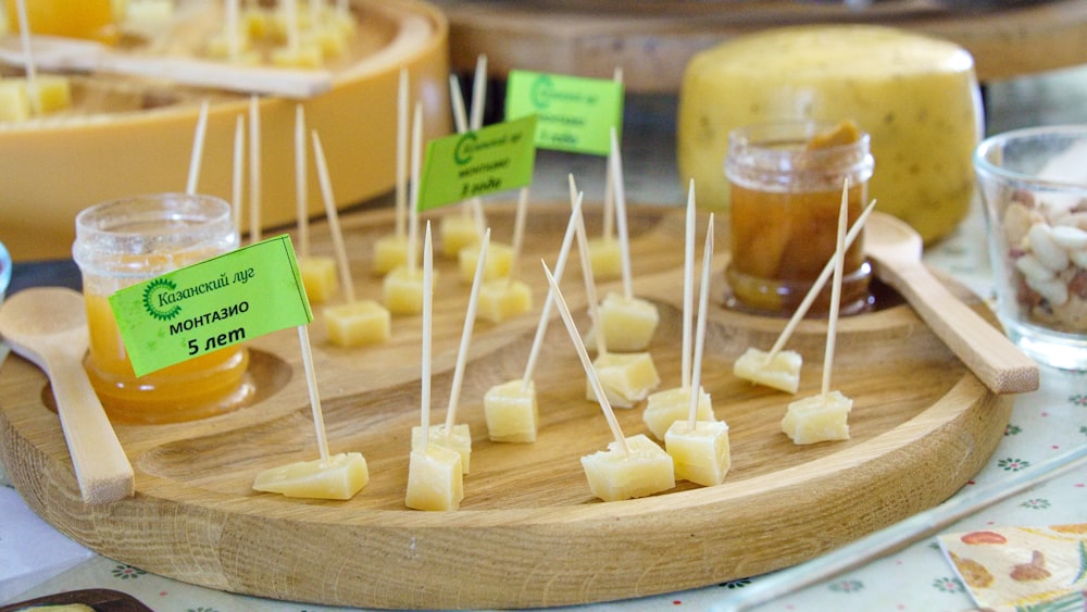 a wooden tray topped with lots of food