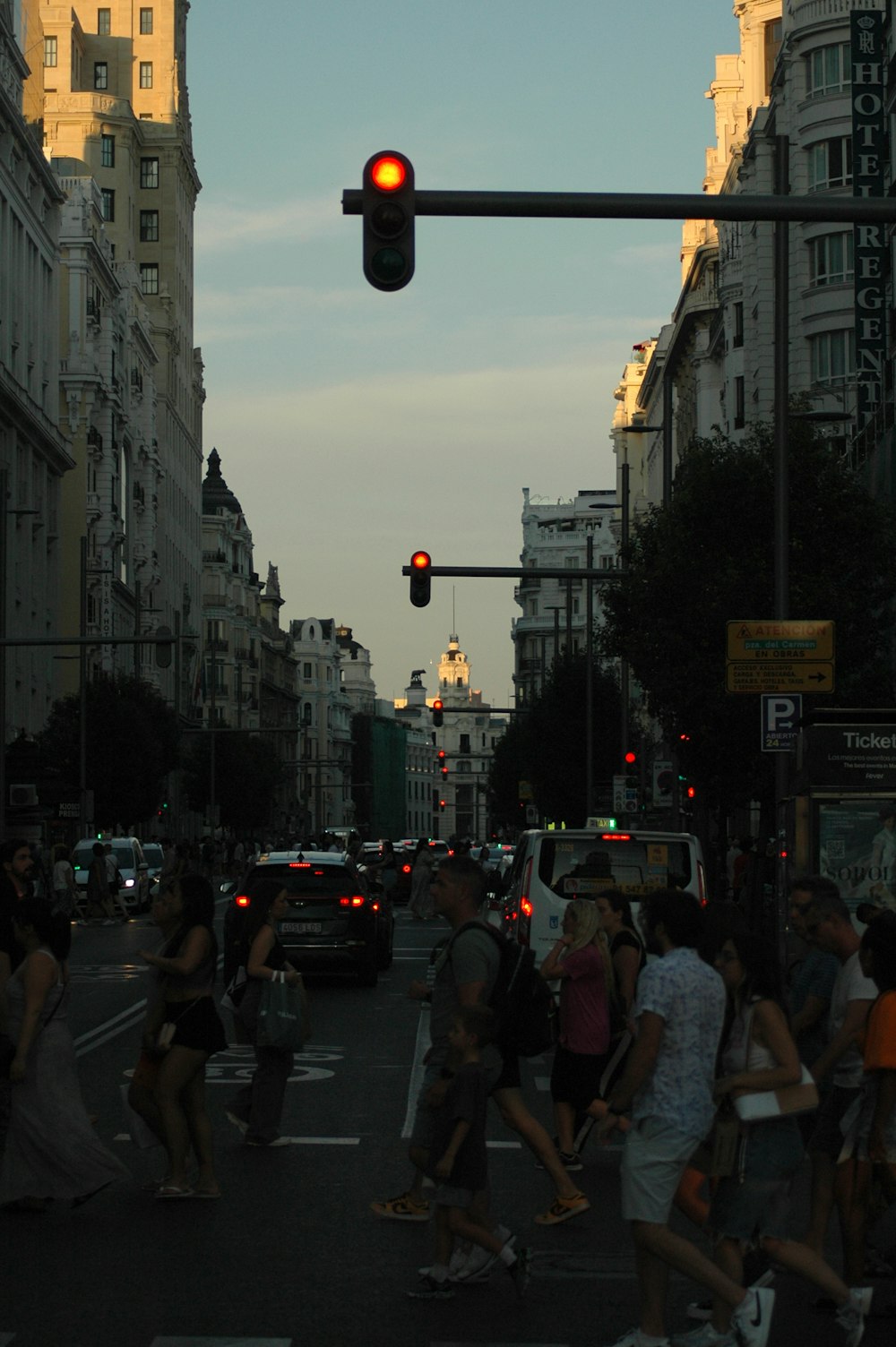 a group of people crossing a street at a traffic light