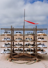 A printed tournament schedule pinned on a wooden board with beach soccer balls nearby