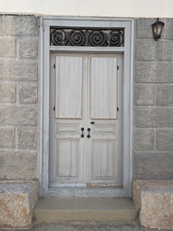 Close-up of a rustic wooden door with vintage ironwork in a historic Piedmont town.