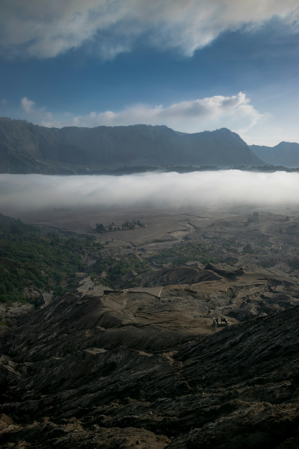 a view of a mountain range with low lying clouds