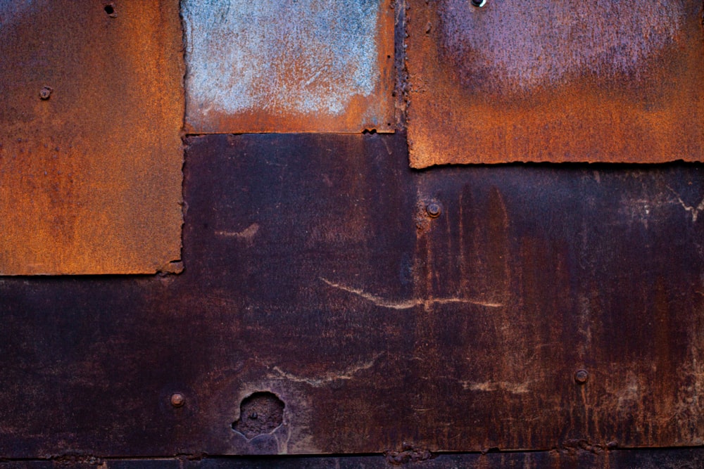 an old rusted metal wall with peeling paint