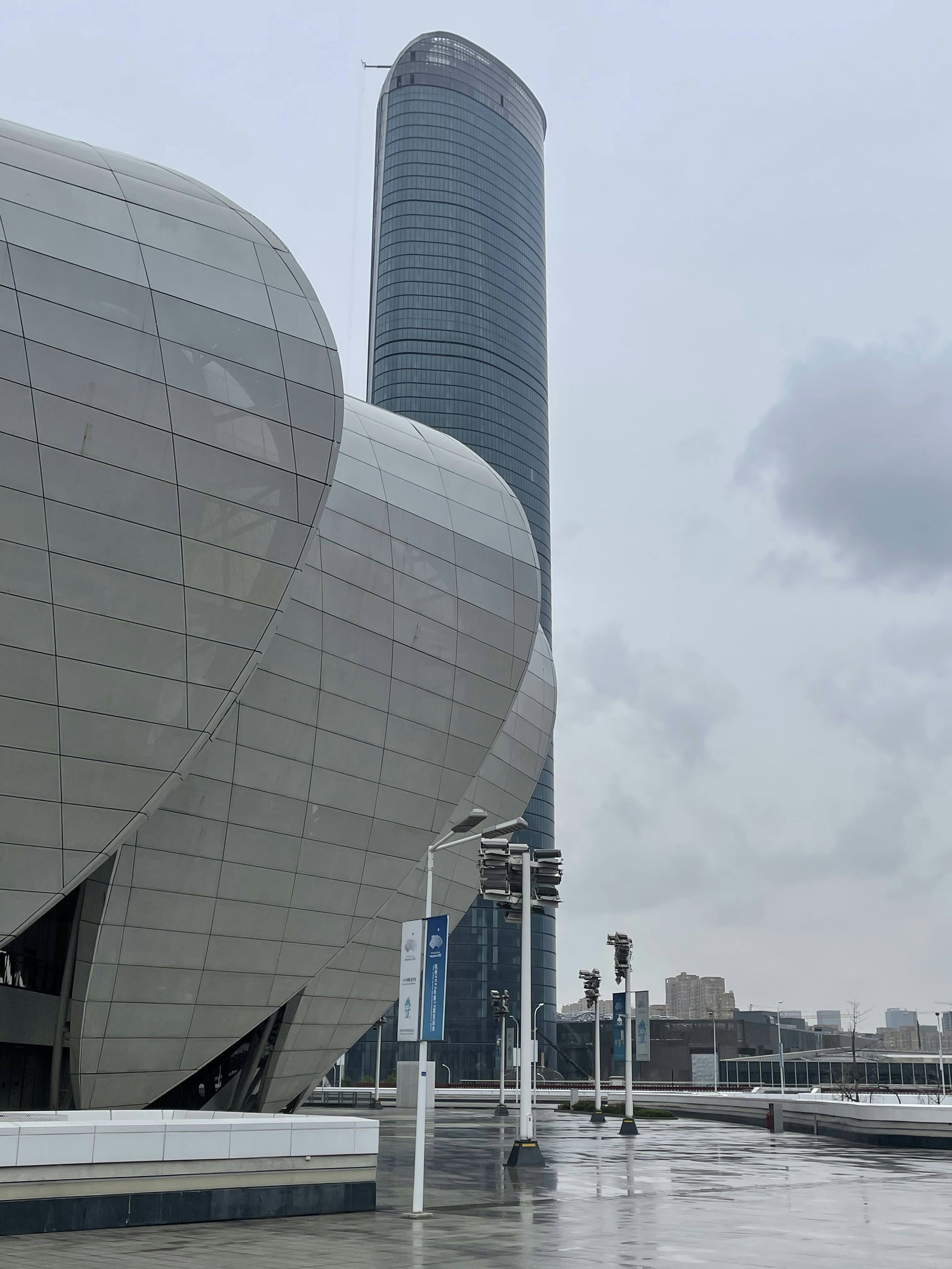 a very large building with a very tall building in the background