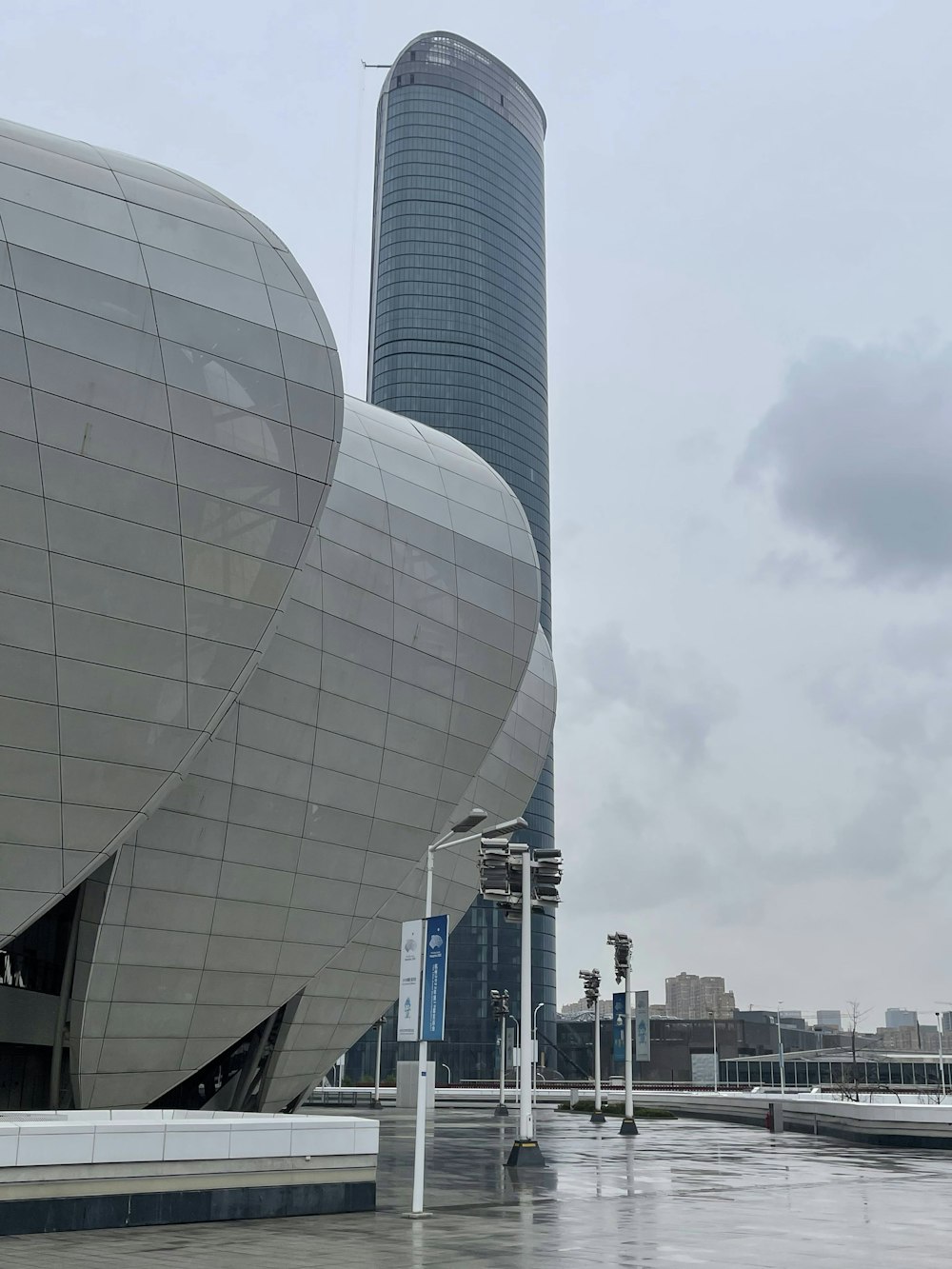 a very large building with a very tall building in the background