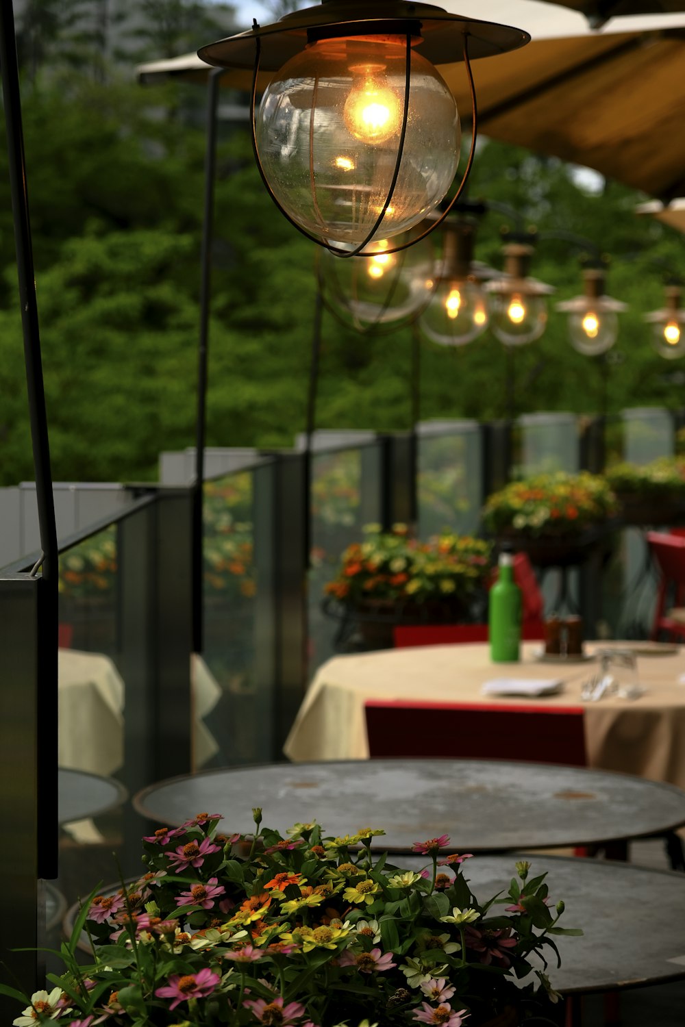 un patio con mesas y luces colgantes