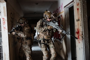 a couple of soldiers walking down a hallway