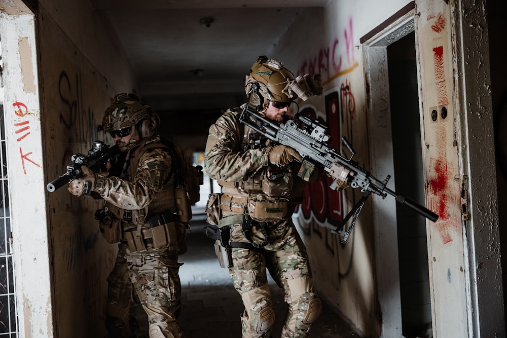 a couple of soldiers walking down a hallway