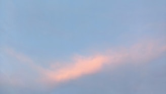 A serene blue sky blending into soft pastel clouds, evoking calm and clarity.