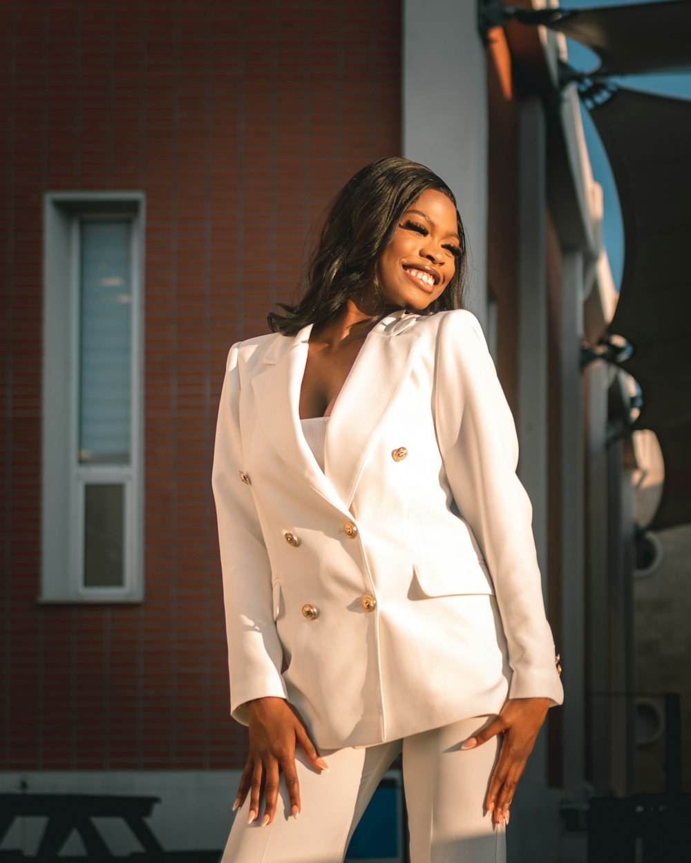 a woman in a white suit posing for a picture