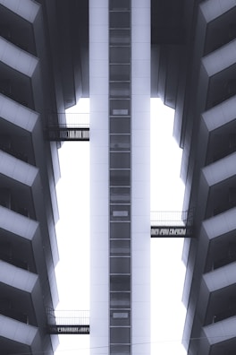 Exterior shot of a high-rise building with multiple elevator shafts visible.