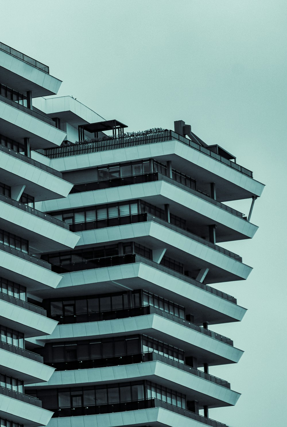 a tall building with balconies on top of it