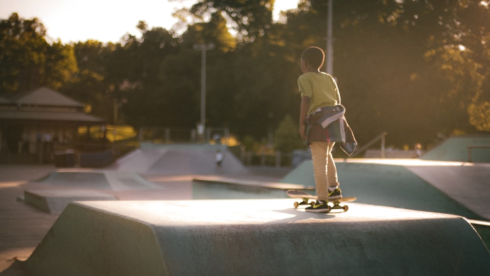 a young man riding a skateboard on top of a ramp