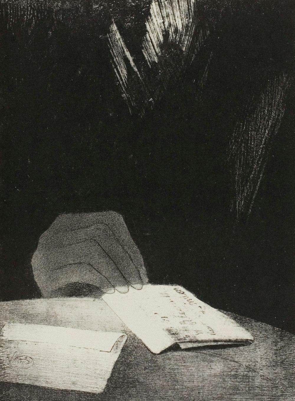 a black and white photo of a person sitting at a table