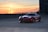 a red sports car parked in a parking lot