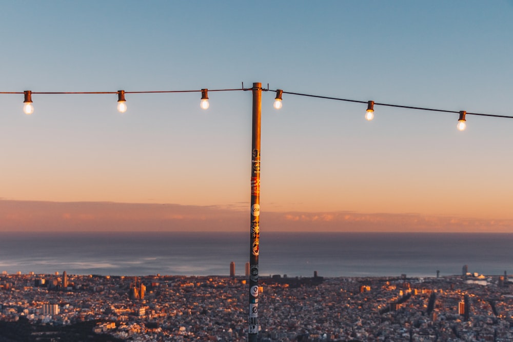 a street light with a city in the background