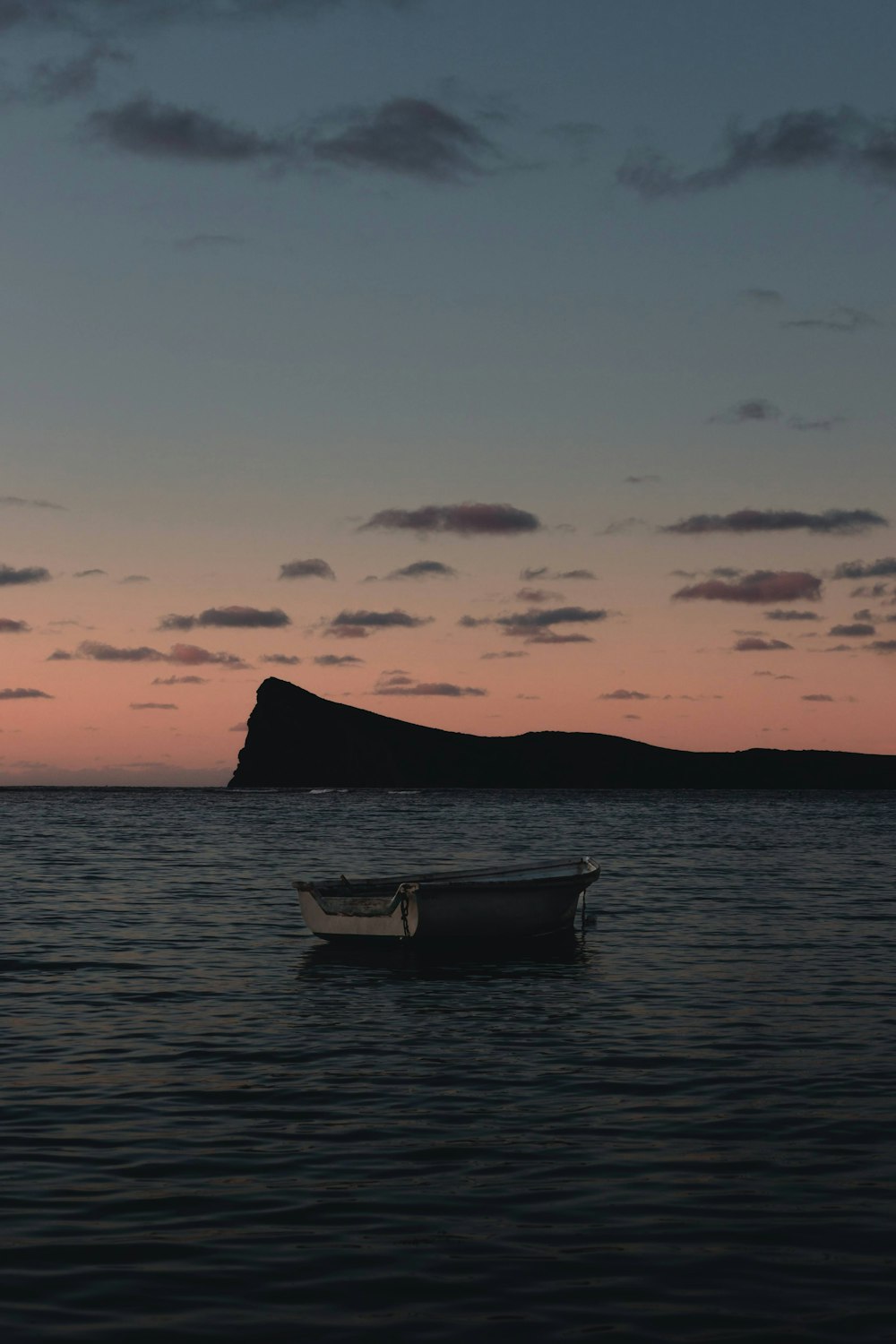 a small boat floating on top of a body of water