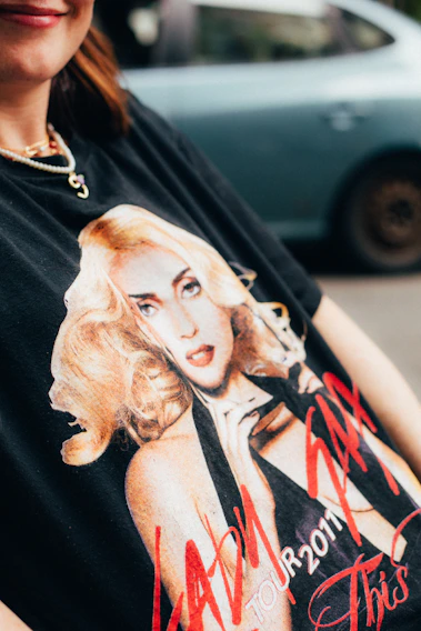 A close-up of a vintage band t-shirt with faded colors and a classic rock logo.