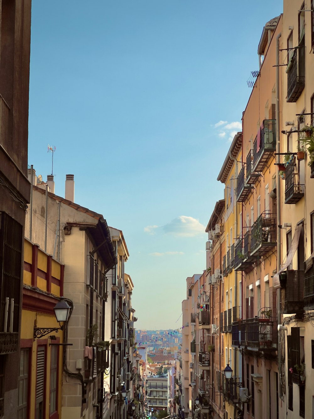 a narrow city street lined with tall buildings