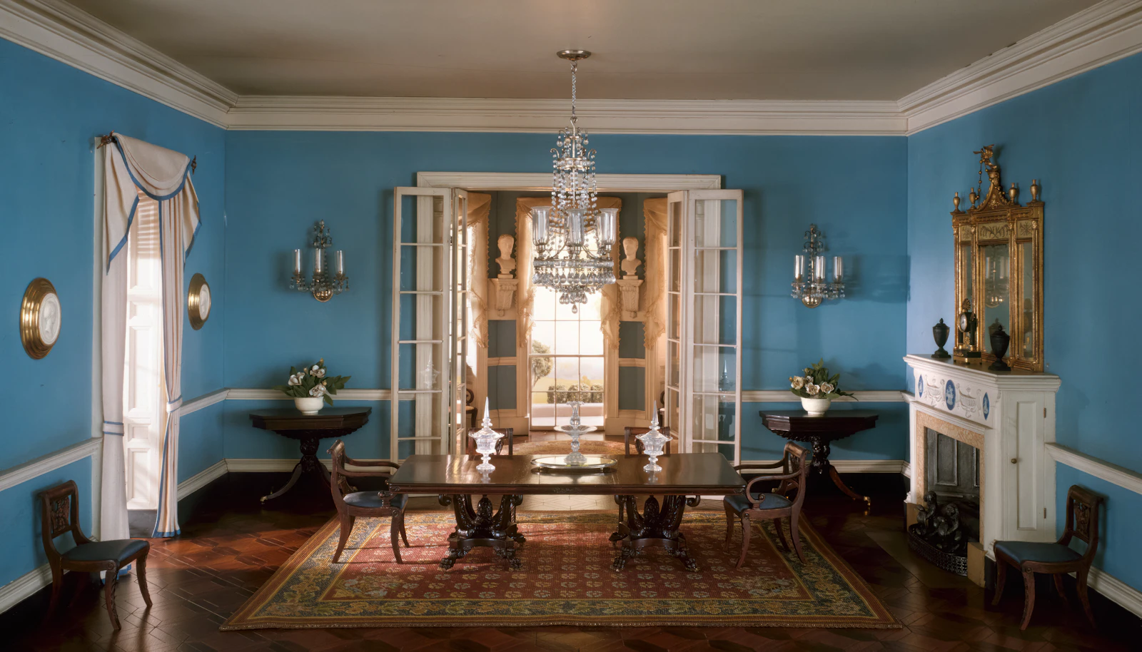 Dining room with blue walls and a chandelier