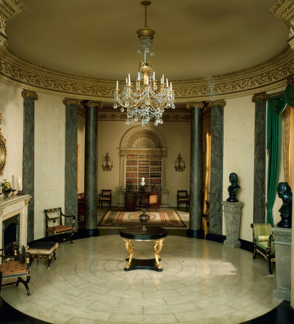 a room with a chandelier and a table in it