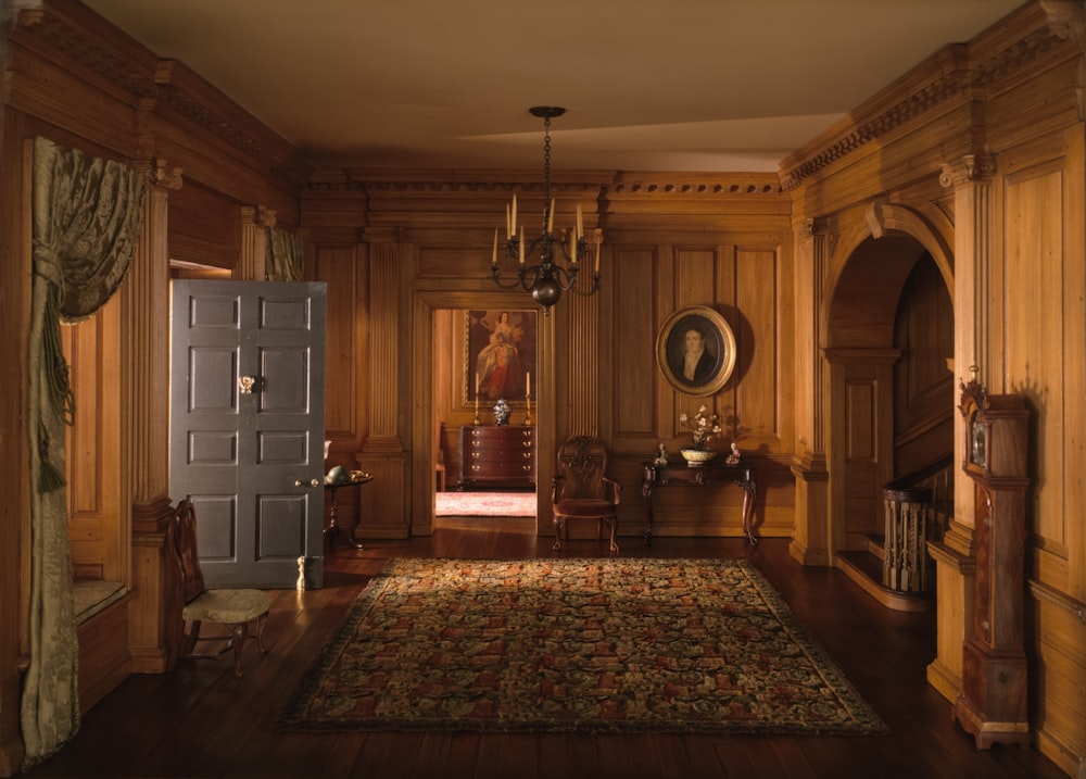 a living room with a rug and a blue door