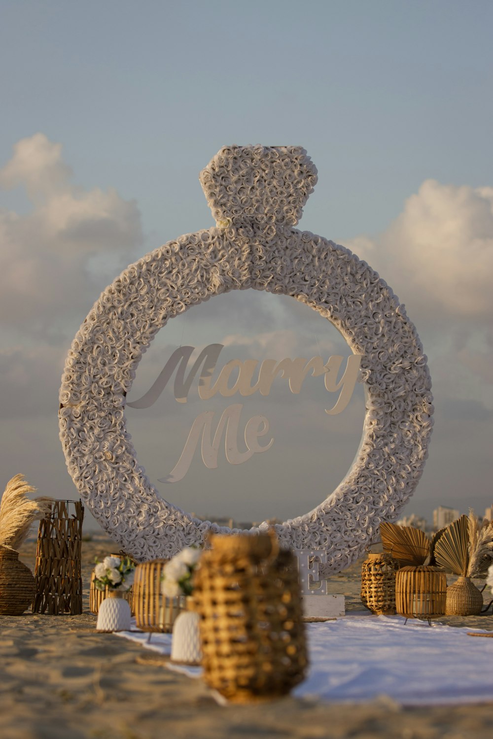 a sign that says marry me on a beach