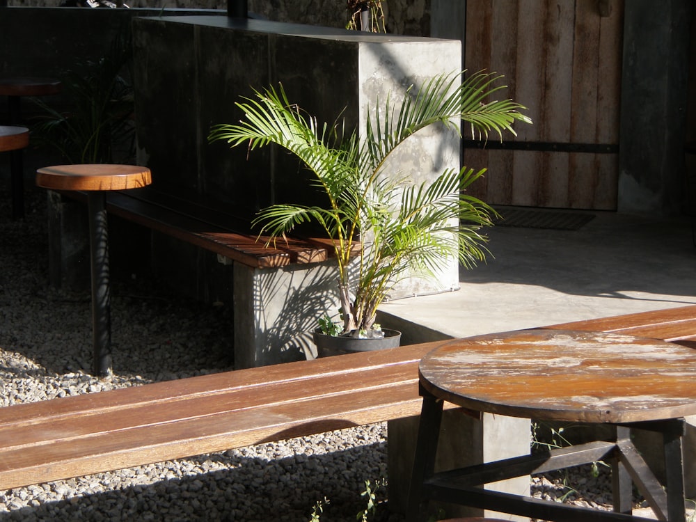 a wooden bench sitting next to a wooden table